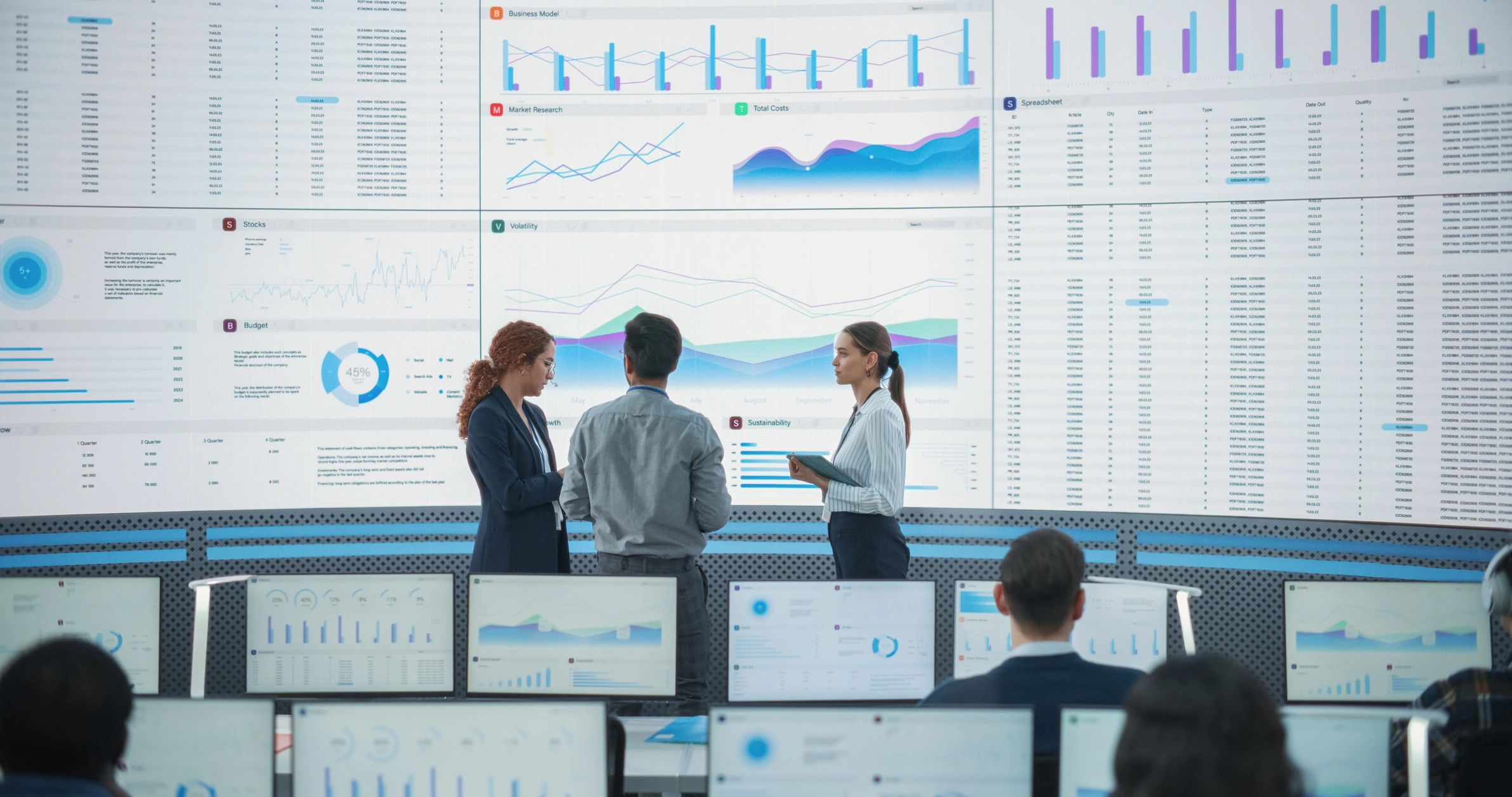 Technology consulting team reviewing data on a large digital screen